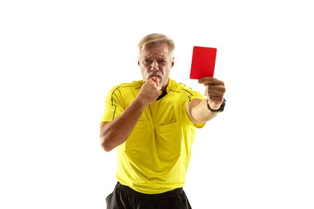 Referee showing a red card to a displeased football or soccer player while gaming isolated on white studio background. Concept of sport, rules violation, controversial issues, obstacles overcoming.の写真素材