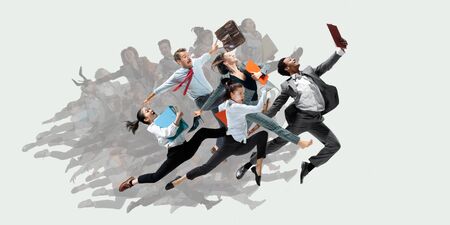 Happy office workers jumping and dancing in casual clothes or suit with folders on white. Ballet dancers. Business, start-up, working open-space, motion and action concept. Creative collage.の写真素材