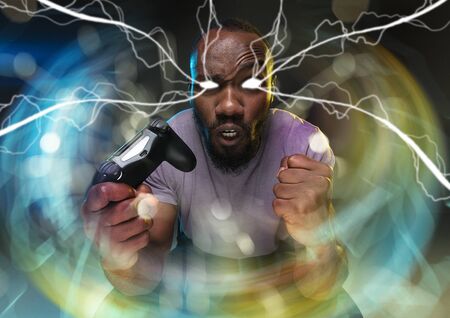 Full immersion in gameplay. Young man holding a video game controller isolated on colorful background. Full of emotions. Leisure activity. Trying to reach the highest level but has the worst team ever.の写真素材