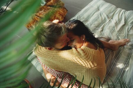 Couple of lovers at home relaxing together. Caucasian man and woman having weekend, looks tender and happy. Concept of relations, family, autumn and winter comfort. Warm holidays. Sense of safety.の写真素材