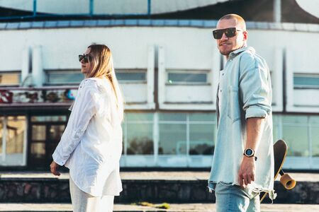 Tanned young caucasian couple, modern lovestory in film grain effect and vintage style. Sunset time....
