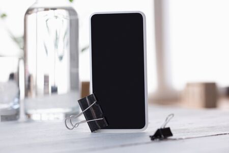 Mock up empty black smartphone screen on blurredの写真素材