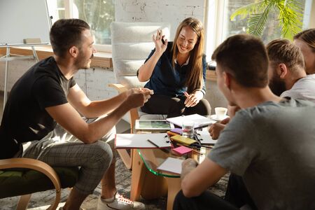 Group of young caucasian office workers meeting to discuss new ideas.