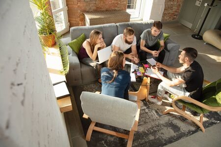 Group of young caucasian office workers meeting to discuss new ideas. Creative meeting. Teamwork and...
