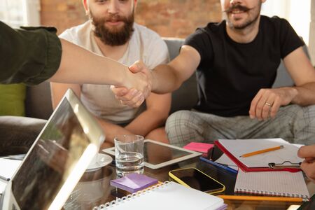 Group of young caucasian office workers meeting to discuss new ideas. Creative meeting. Teamwork and...