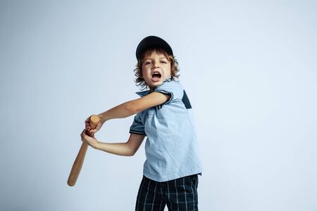Pretty young curly boy in casual clothes on white studio background. Confident and cool with sport...