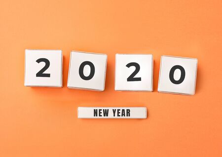 2020 made from white boxes with numbers on orange studio background. New Year's and Merry Christmas concept, celebration and holidays. Copyspace for your advertising.の写真素材