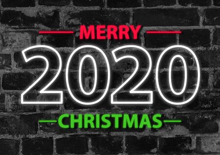 2020 in neon multi colour design, parallel lines pattern on black brick background. Holidays, celebrating night, New Year and Christmas event, bright colors. Copyspace, advertising.の写真素材