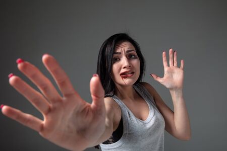 Woman in fear of domestic abuse and violence, concept of female rights. Stop agression. Caucasian...