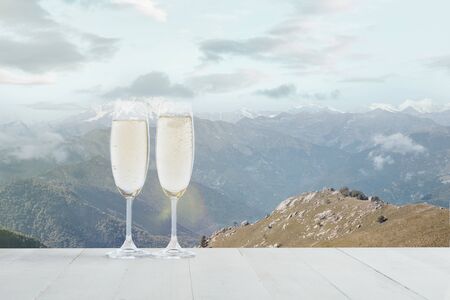 Champagne in glasses and landscape of mountainsの写真素材