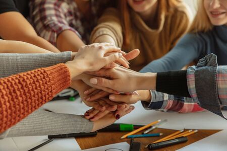 Young people shaking hands while discussing of women rights and equality at the office. Caucasian businesswomen or office workers have meeting about problem in workplace, male pressure and harassment.の写真素材