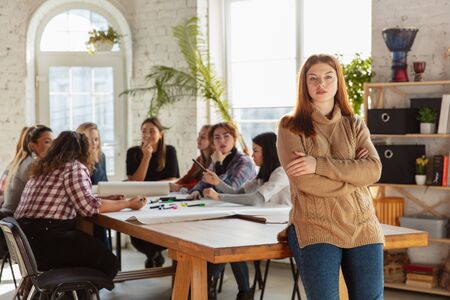Womens rights and equality at the office. Caucasian businesswomen or young confident model crossed hands in front of coworkers having meeting about problem in workplace, male pressure and harassment.の写真素材