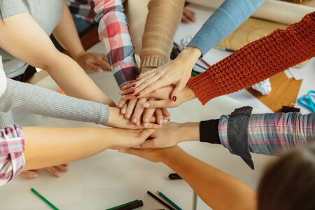Young people shaking hands while discussing of women rights and equality at the office. Caucasian...