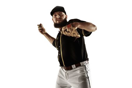 Baseball player, pitcher in a black uniform practicing and training isolated on a white background. Young professional sportsman in action and motion. Healthy lifestyle, sport, movement concept.の写真素材