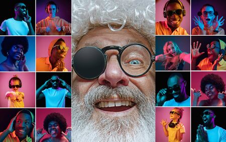 Emotional Santa Claus and his entourage greeting with New Year 2020 and Christmas. Man in traditional costume with multiethnic group of his friends in neon lights. Concept of holidays, winter mood.の写真素材