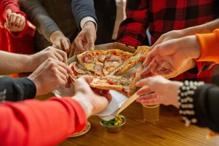 Happy co-workers celebrating while company party and corporate event. Young caucasian people in...