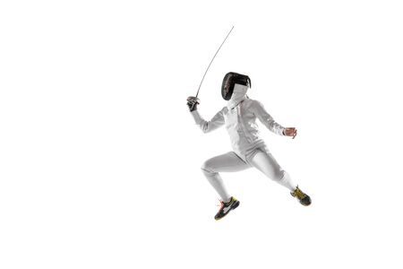 Teen girl in fencing costume with sword in hand isolated on white studio background. Young female...