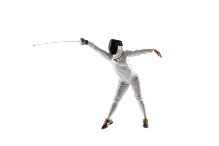 Teen girl in fencing costume with sword in hand isolated on white studio background. Young female...
