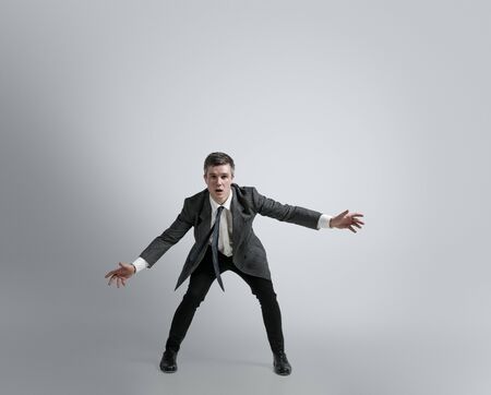 Dreams about big possibilities. Man in office clothes traines in football or soccer like goalkeeper...