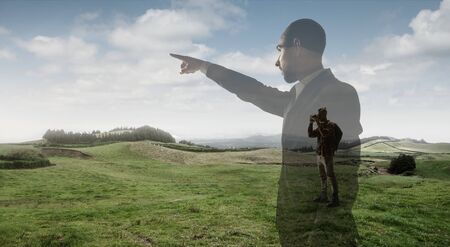 Pointing on. Businessman with mountain landscapes, double exposure.の写真素材