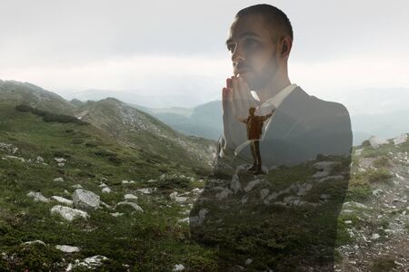 Concentrated. Businessman with mountain landscapes, double exposure.の写真素材