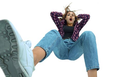 A second before falling. Caucasian young girl falling down in moment with bright emotions and facial...