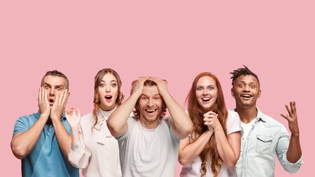 Portrait of multiethnic group of young people isolated on pink studio background, flyer, collage....