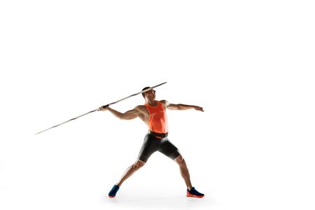 Male athlete practicing in throwing javelin isolated on white studio background. Professional sportsman training in motion, action. Concept of healthy lifestyle, movement, activity. Copyspace.の写真素材