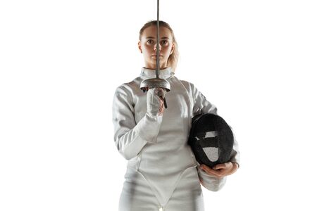 Champion. Teen girl in fencing costume with sword in hand isolated on white background. Young female...