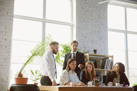 Positive. Group of young business professionals having a meeting. Diverse group of coworkers...