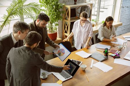 Creative process. Group of young business professionals having a meeting. Diverse group of coworkers discuss new decisions, plans, results, strategy. Creativity, workplace, business, finance, teamwork.の写真素材