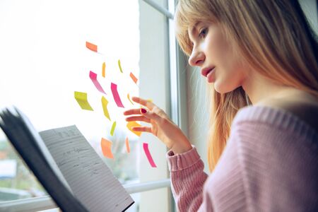 Beautiful caucasian business lady working in office. Young female model in co-working place makes...