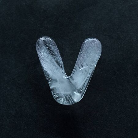 Melting speech. Alphabets shiny and well-structured letters made out of ice isolated on dark studio background. Collect for combine in words. Copyspace to insert your advertising.の写真素材