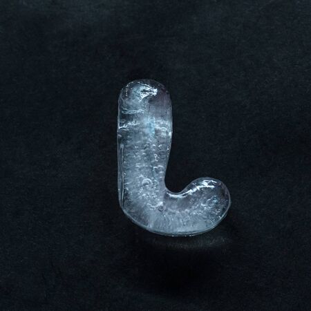 Melting speech. Alphabets shiny and well-structured letters made out of ice isolated on dark studio...