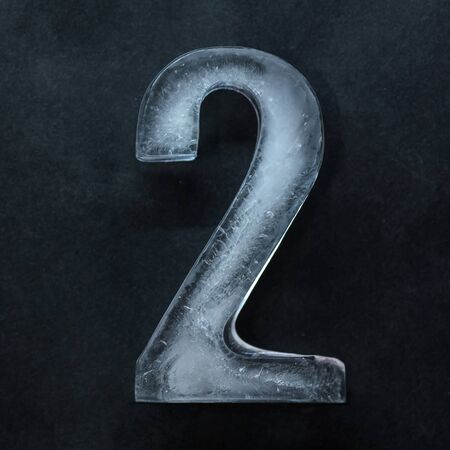 Melting. Numeric value, numbers made out of shiny and well-structured ice isolated on dark studio background. Collect for combine in number. Copyspace to insert your advertising.の写真素材