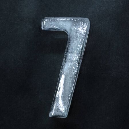 Melting. Numeric value, numbers made out of shiny and well-structured ice isolated on dark studio background. Collect for combine in number. Copyspace to insert your advertising.の写真素材