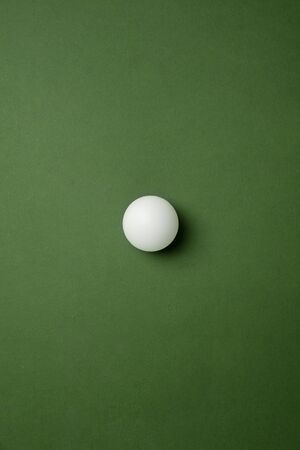 Bright table tennis,   ball. Professional sport equipment isolated on green studio background....