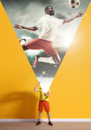 Would be champion. Young caucasian man with smartphone, serfing, opening world with his gadget isolated on yellow background. Concept of modern technologies, millennials, social media, dreaming.の写真素材