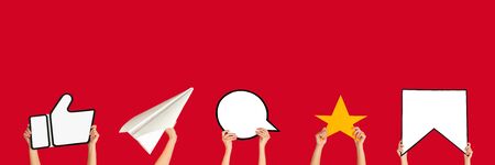 Hands holding the signs of social media on red studio background, flyer. Copyspace for your text or image, advertising. Showing meaning, gadgets, modern technologies, comments, message, interactions.の写真素材