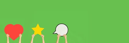 Hands holding the signs of social media on green studio background, flyer. Copyspace for your text...