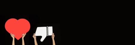 Hands holding the signs of social media on black studio background, flyer. Copyspace for your text...