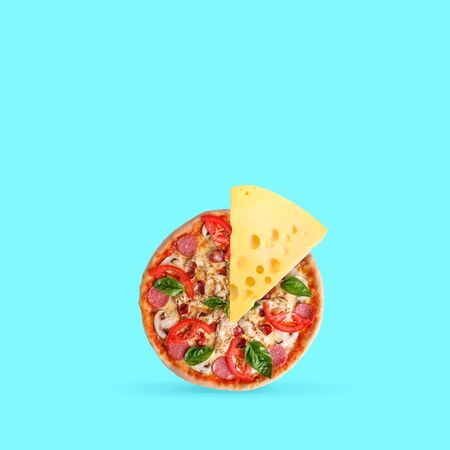 Double cheese. Pizza with tomatos and spices with big cheesy peace on blue background. Copyspace....