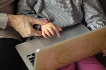 Happy loving family. Grandmother and grandchild spending time together. Watching cinema, using...