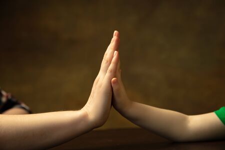 Holding hands, clapping like friends. Close up shot of female and kid's hands doing different things...
