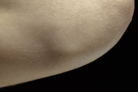 Beauty. Detailed texture of human skin. Close up shot of young caucasian female body. Skincare,...