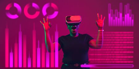 Woman using interface modern technology, digital layer with VR headset as economics learning...