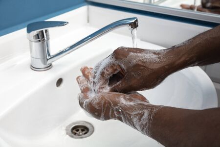 Man washing hands carefully with soap and sanitizer, close up. Prevention of pneumonia virus spreading, protection against coronavirus pandemia. Hygiene, sanitary, cleanliness, disinfection. Safety.の写真素材