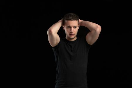 Posing confident. Monochrome portrait of young caucasian man isolated on black studio background....