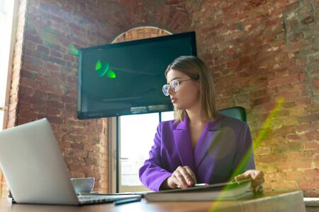 Busy. Young caucasian business-woman working in office, looks stylish. Paperwork, analyzing, looking...