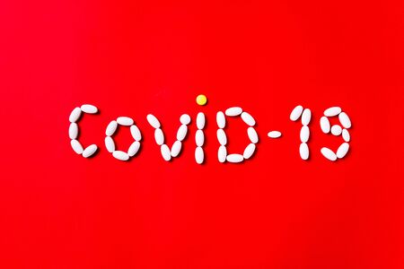 Weapon against COVID-19. Colored pills, tablets and capsules on a red background - history of treatment. Concept of healthcare and medicine, vaccine, prevention of pandemic, epidemic, chronic diseases.の写真素材